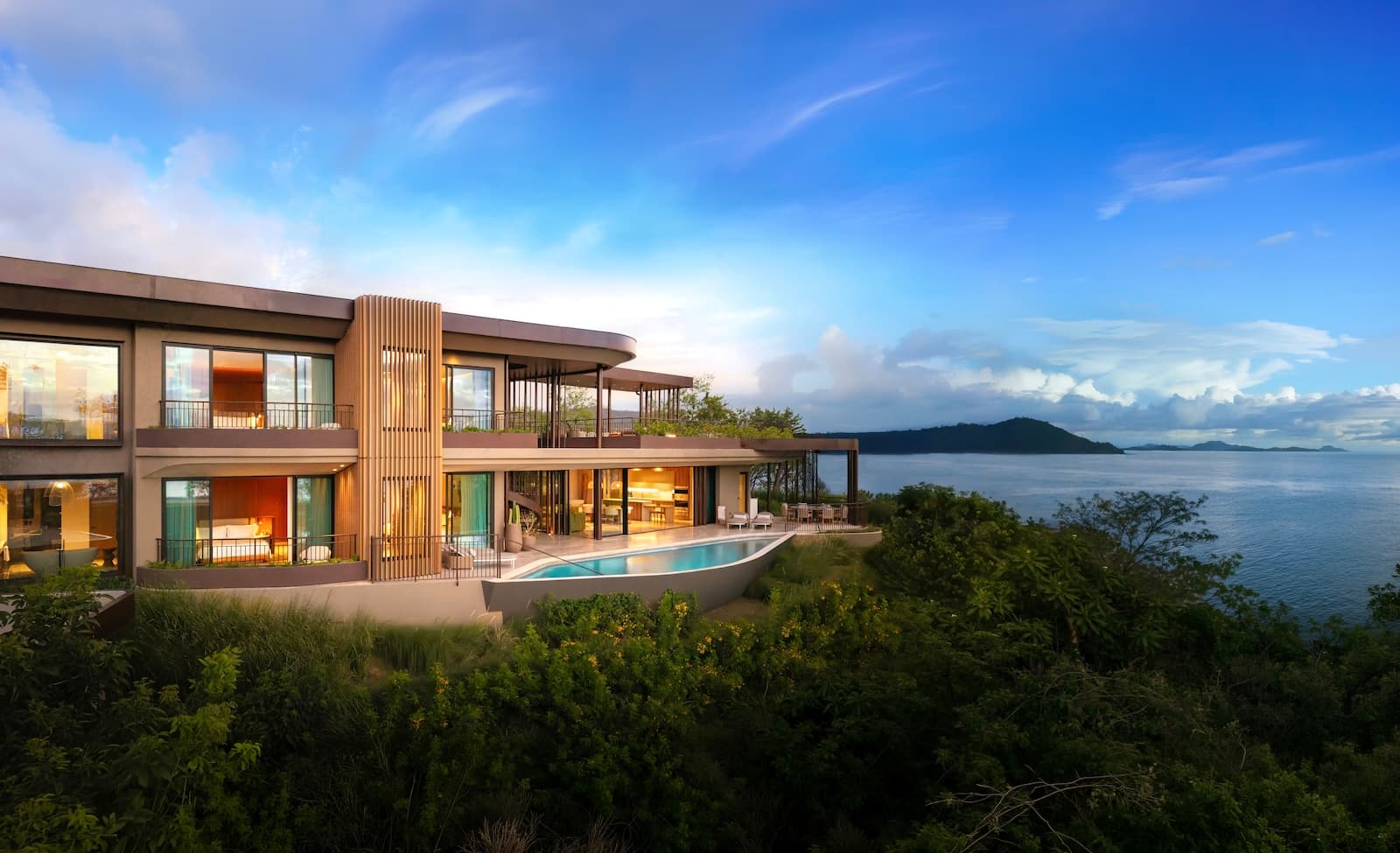 Luxury oceanfront estate home with an infinity pool, expansive terraces, and panoramic views of the sea and nearby islands.