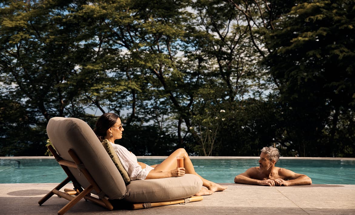 A couple poolside at the Presidential Suite at the Waldorf Astoria Punta Cacique Costa Rica