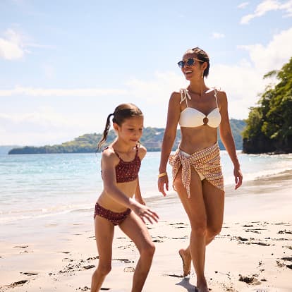 Waldorf Astoria Punta Cacique Costa Rica mother and child walking along the sandy beaches of Playa Penca
