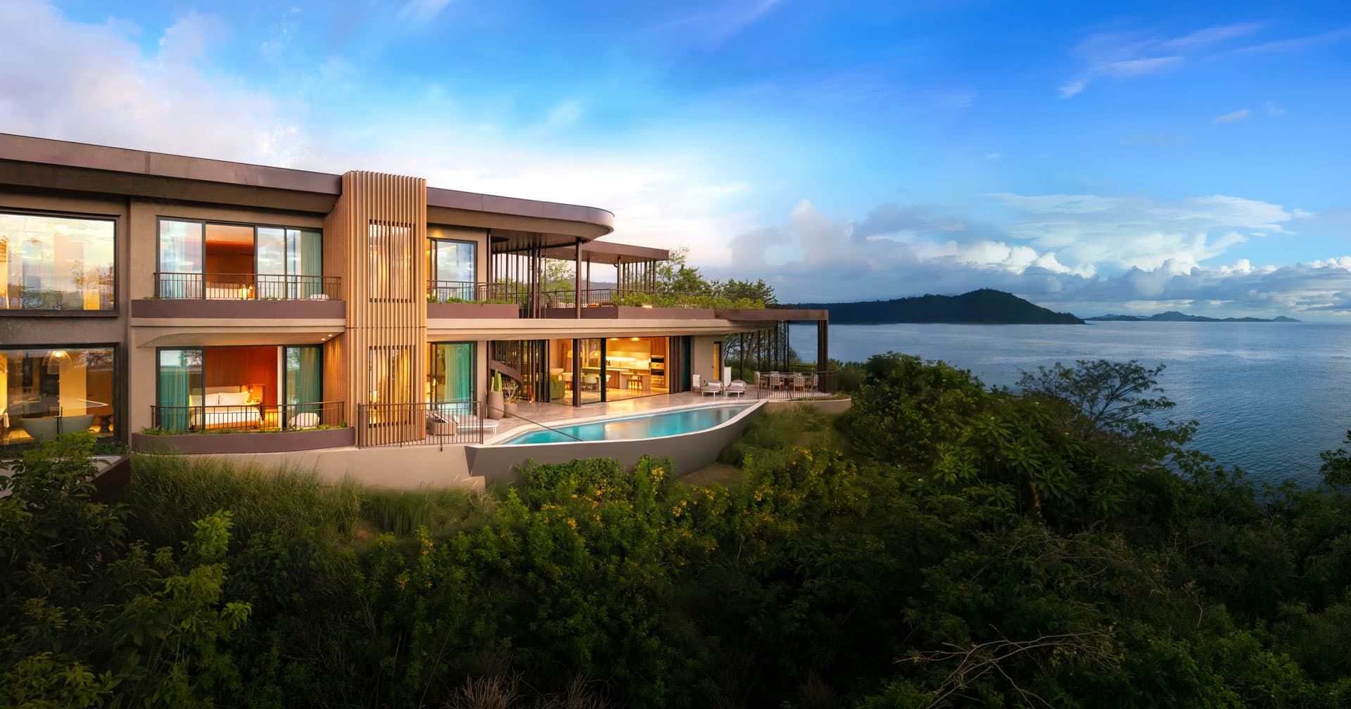 Luxury oceanfront estate home with an infinity pool, expansive terraces, and panoramic views of the sea and nearby islands.